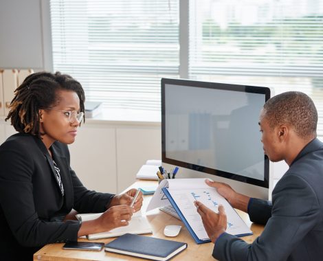 Female entrepreneur listening to report of financial manager